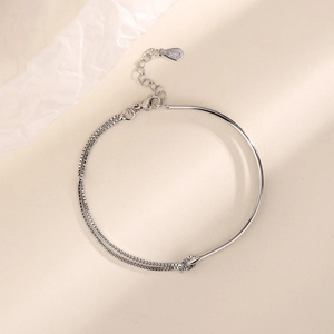 Macro view of S925 sterling silver stamp on minimalist knotted chain bracelet
