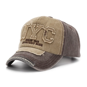 Detail of vintage NYC embroidered patch and distressed brim on khaki baseball cap