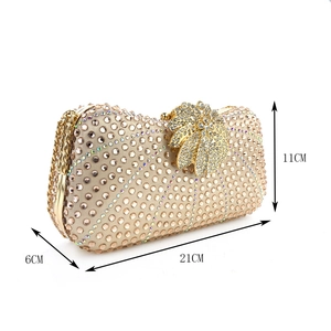 Detail view of champagne evening clutch with 21x6x11cm dimensions and crystal lock