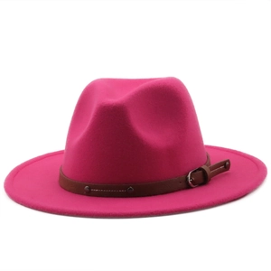 Detail of rose red fedora hat featuring a wool felt texture and brown buckled leather band