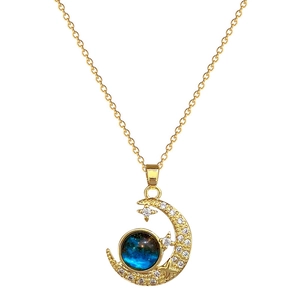 Elegant gold celestial necklace with diamond-encrusted moon and blue star pendant