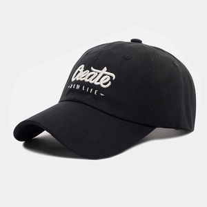 Detail of white 3D embroidery 'Create NEW LIFE' on a black cotton baseball cap