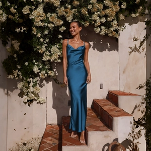 Detailed view of the elegant cowl neck design and satin texture on a blue maxi dress
