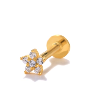 Macro detail of gold flower flat back stud earring with clear sparkling crystals