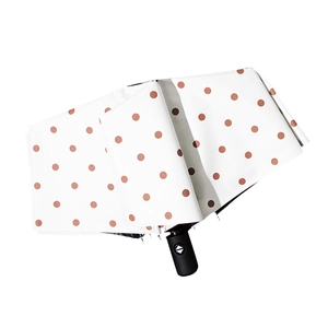 White polka dot automatic umbrella with UV protection and black matte handle on white background