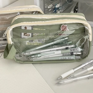 Detail of green mesh pencil case with transparent window showing stationery organization