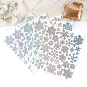 Macro view of holographic snowflake stickers with glitter texture for winter DIY decor
