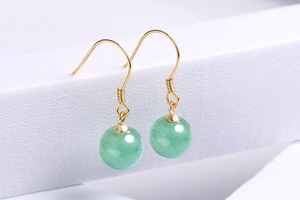 Macro shot of S925 silver gold-plated hooks with green aventurine jade beads