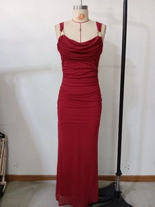 Detail of red slim fit dress showing elegant cowl neck and gold metal ring strap buckles