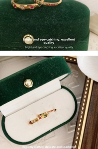 Detail of 18k gold plated titanium ring with rainbow zircons and star engraving