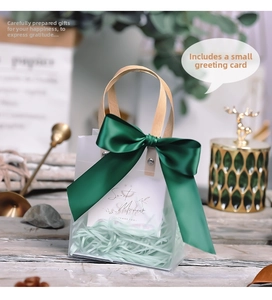 Frosted transparent gift bag featuring a dark green satin bow and thank you card insert