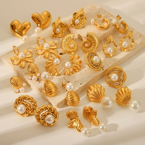 Collection of French style 18K gold plated stainless steel pearl earrings on stone base