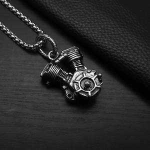 Detailed view of punk engine pendant on dark leather surface with metallic texture