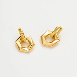 Elegant gold geometric hexagonal earrings with a polished metallic finish on grey background