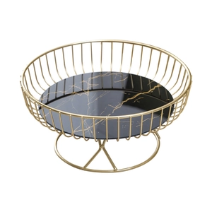 Nordic gold metal wire fruit basket with black marble glass base in a top-down view