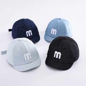 Detail of baby denim baseball caps with m embroidery in four assorted colors