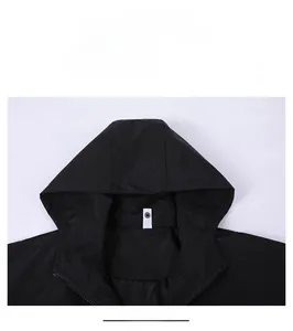 Detail view of the windproof hood and durable black fabric of the hooded jacket