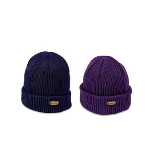 Navy and purple knitted beanies for kids featuring classic deer head leather patches