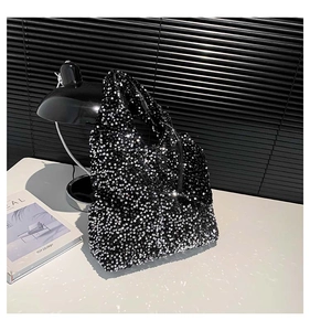 Close-up of sparkling black sequins texture on a large tote bag with silver reflections