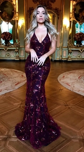 Detail of burgundy sequin fabric texture on a deep V-neck mermaid evening gown