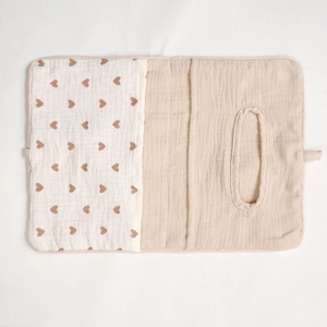 Detail of baby cotton storage bag featuring heart pattern and wet wipe dispenser opening