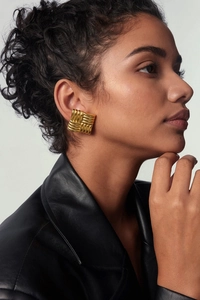 Close-up of model wearing square woven textured 18k gold stainless steel hoop earrings