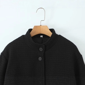 Women's black waffle texture stand collar jacket with long sleeves and button closure