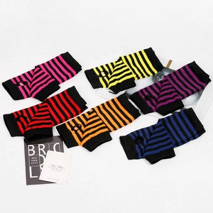 Detailed view of colorful striped knit fingerless gloves with thumb holes and ribbed cuffs