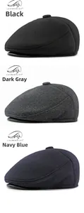 Detailed view of vintage newsboy caps in black, dark grey, and navy blue wool fabric