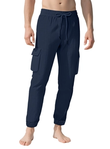Detail of dark blue cargo joggers featuring large side pockets and drawstring waist