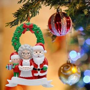 Personalized resin Santa Claus family ornament hanging on a Christmas tree branch