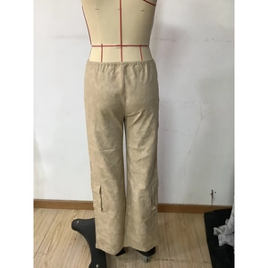 Detailed view of high-waist elastic waistband and large side cargo pockets on khaki pants
