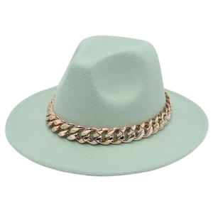 Detail of mint green wool fedora hat featuring a chunky gold acrylic chain decoration