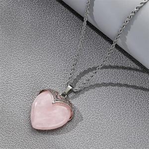 Close-up of heart-shaped pink crystal pendant with elegant silver rope chain