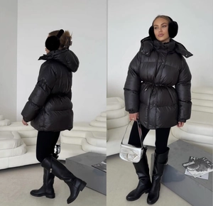 Detail view showing front and side profile of black drawstring hooded puffer coat