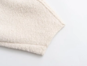 Detailed close-up showing the soft cream sherpa fleece texture of the women's cropped sweatshirt
