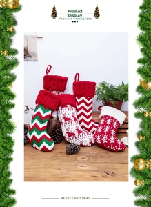 Detailed view of four knitted Christmas stockings with reindeer and snowflake patterns