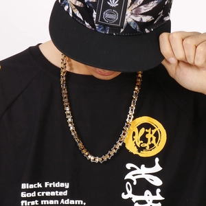 Detail of two-tone 18K gold plated geometric chain necklace on model in streetwear style