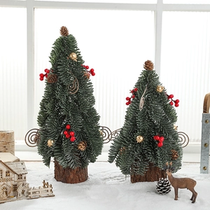 Mini artificial Christmas trees with snow, red berries, and pinecones on wood bases