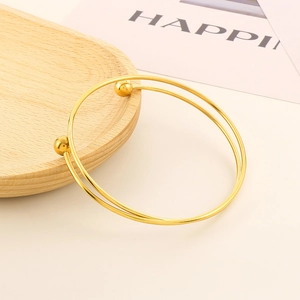 Minimalist double-layered gold stainless steel open bangle with spherical ends