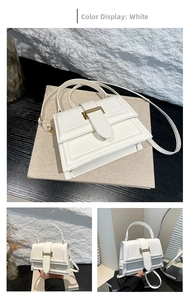 Detailed close-up showing the golden metal buckle and white leather of the square crossbody bag