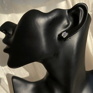 Sparkling Aurora crystal square stud earring displayed on a black model silhouette