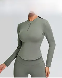 Detail of sage green yoga set with slim fit half-zip top and curved hem silhouette