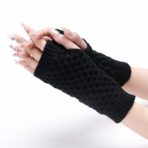 Detailed knit texture of short pineapple pattern fingerless gloves in black yarn