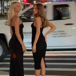 Street style view of two slim-fit black bodycon dresses with halter and strapless design