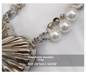 Detail view of the silver shell bag with detachable pearl strap and metal lobster clasp