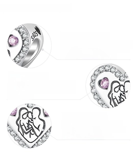 Macro view of S925 sterling silver heart charm with pink cubic zirconia and fine engraving