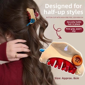 Detail of 8cm button-decorated hair claw clip showing size and secure grip for half-up hair