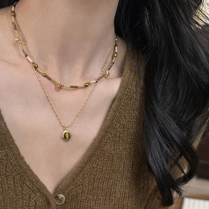 Double-layered gold-plated necklace featuring tiger eye stone oval pendant for women