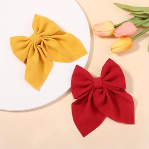 Close-up of large floral chiffon bow hair clips with elegant jacquard texture details
